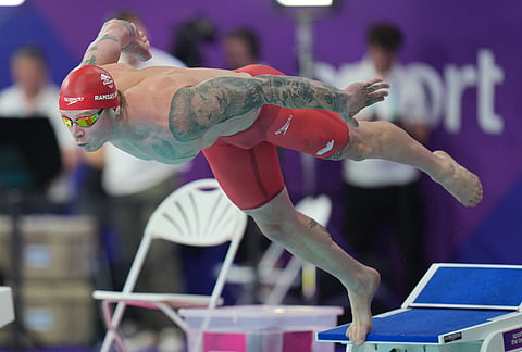 Adam Ramsay-Peaty dives off as he starts in the 2nd semifinal of the men's 100 meter breaststroke swimming event during the Commonwealth Games in Glasgow, Scotland, Friday, July 24, 2026.