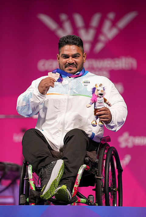 India's Jhandu Kumar celebrates after winning the bronze medal during the medal ceremony for the men's heavyweight para powerlifting event at the Commonwealth Games 2026, in Glasgow, Friday, July 24, 2026. 