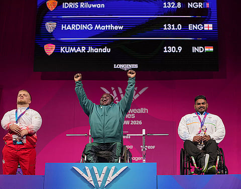 India's Jhandu Kumar, right, celebrates after winning the bronze medal alongside gold medallist Idris Riluwan of Nigeria, centre, and silver medallist Matthew Harding of England during the medal ceremony for the men's heavyweight para powerlifting event at the Commonwealth Games 2026, in Glasgow, Friday, July 24, 2026. 
