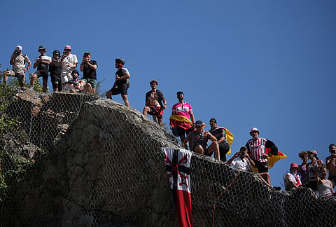 Spectators wait for the riders in the Alpe d'Huez during the nineteenth stage of the Tour de France cycling race with start in Gap and finish in Alpe d'Huez, France, Friday, July 24, 2026. 