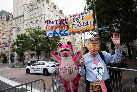 Demonstrators protest outside of the White House Correspondents' Association dinner at the Waldorf Astoria Washington DC hotel, in Washington.