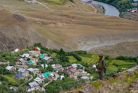 A security official stands guard during an event of 'Kargil Vijay Diwas' celebrations, in Drass district, Ladakh.