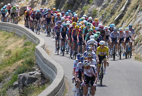 Slovenia's Tadej Pogacar, wearing the overall leader's yellow jersey, rides in the pack during the nineteenth stage of the Tour de France cycling race with start in Gap and finish in Alpe d'Huez, France, Friday, July 24, 2026. 