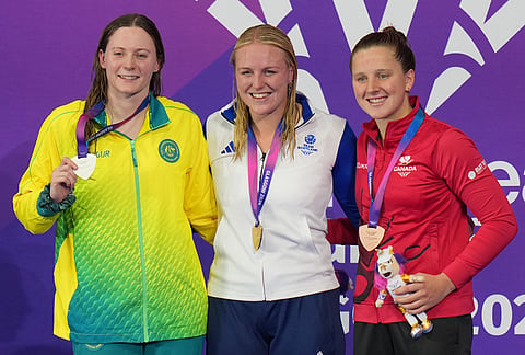 Faye Rogers of Scotland, center, gold medal, with Jasmine Greenwood of Australia, silver, left, and Mary Jibb of England, bronze, pose on the podium during the medal ceremony for the women's 200 meter individual medley SM10 swimming event during the Commonwealth Games in Glasgow, Scotland, Friday, July 24, 2026. 