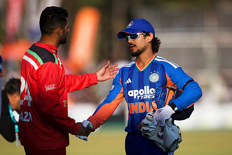 India's wicketkeeper Ishan Kishan, right, shakes hand with Zimbabwe's captain Sikandar Riza during the second T20 cricket match between Zimbabwe and India in Harare, Zimbabwe.