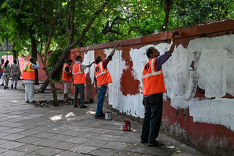 NDMC workers clear the protest site at Jantar Mantar after the Cockroach Janta Party (CJP) calls off its agitation following the resignation of Union Education Minister Dharmendra Pradhan, in New Delhi.