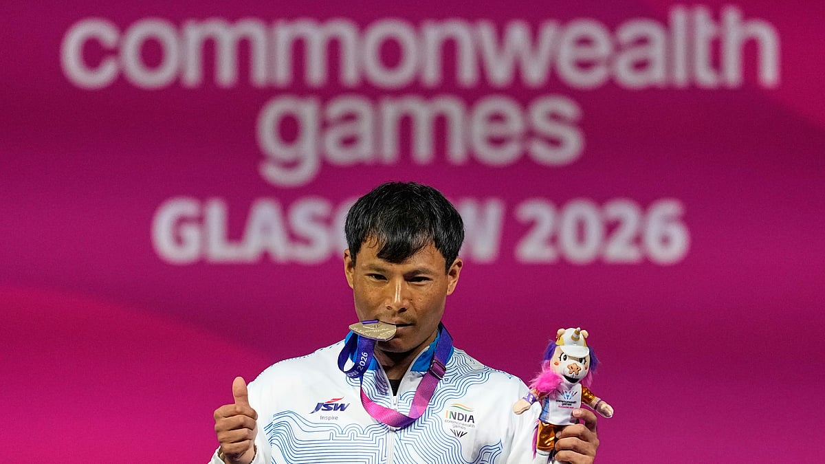 India's Rishikant Chanambam Singh celebrates after wining silver medal in 60 kilogram clean and jerk weightlifting during the Commonwealth Games in Glasgow, Scotland, Sunday, July 26, 2026. - (AP Photo/Manish Swarup)