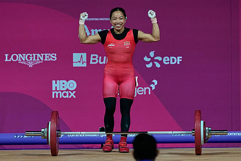 India's Mirabai Chanu celebrates after a successful lift in the women's 48 kilogram weightlifting during the Commonwealth Games, in Glasgow, Scotland