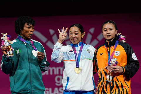 From left, silver medalist Nigeria's Ruth Asuquo Nyong, gold medalist India's Mirabai Chanu and bronze medalist Malaysia's Irene Jane Henry celebrate on the podium for the women's 48 kilogram weightlifting, during the Commonwealth Games in Glasgow, Scotland.
