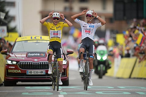 Slovenia's Tadej Pogacar, left, and Mexico's Isaac Del Toro, right, react as they cross the finish line of the twentieth stage of the Tour de France cycling race with start in Le Bourg d'Oisans and finish in Alpe d'huez, France.