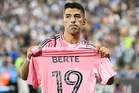 Inter Miami CF's Luis Suarez holds up the jersey of teammate German Berterame after scoring a penalty kick against CF Montreal during second half MLS soccer action in Montreal. Berterame was taking out of the game following an injury.