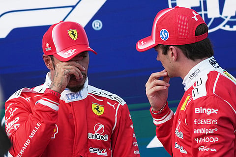 Ferrari driver Lewis Hamilton of Britain, left, talks to Ferrari driver Charles Leclerc of Monaco after the qualifying session ahead of Sunday's Formula One Hungarian Grand Prix auto race, at the Hungaroring racetrack in Mogyorod, near Budapest, Hungary.