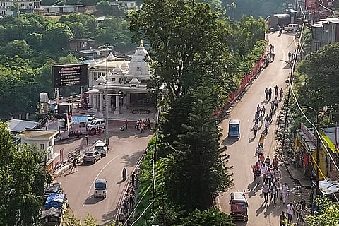 People proceed along the pilgrimage route to Mata Vaishno Devi shrine after the yatra resumes following a six-day suspension, in Katra, Jammu and Kashmir.