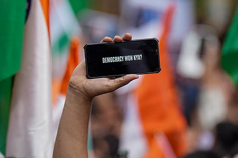 A man takes part in a rally held by Shiv Sena (UBT) chief Uddhav Thackeray, unseen, and MNS chief Raj Thackeray, unseen, to celebrate the resignation of Union Education Minister Dharmendra Pradhan, in Mumbai.