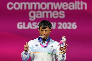 | Photo: AP/Manish Swarup : India's Rishikant Chanambam Singh celebrates after wining silver medal in 60 kilogram clean and jerk weightlifting during the Commonwealth Games in Glasgow, Scotland.