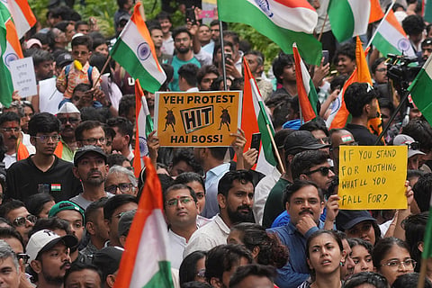 Protesters celebrate after Education Minister Dharmendra Pradhan resigned following nationwide protests as part of the Cockroach Janta Party's protest movement in Mumbai, India.