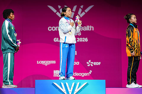India's gold medallist Mirabai Chanu, centre, Nigeria's silver medallist Ruth Asuquo Nyong, left, and Malaysia's bronze medallist Irene Jane Henry during the presentation ceremony after the women's 48kg Final weightlifting competition at the 23rd Commonwealth Games, in Glasgow, Scotland.