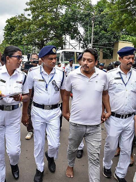 Police personnel make an accused walk barefoot after his connection in the alleged attack on media personnel during the rally of left students wing and CJP supporters on NEET paper leak issue, at Espalande area, in Kolkata, West Bengal.