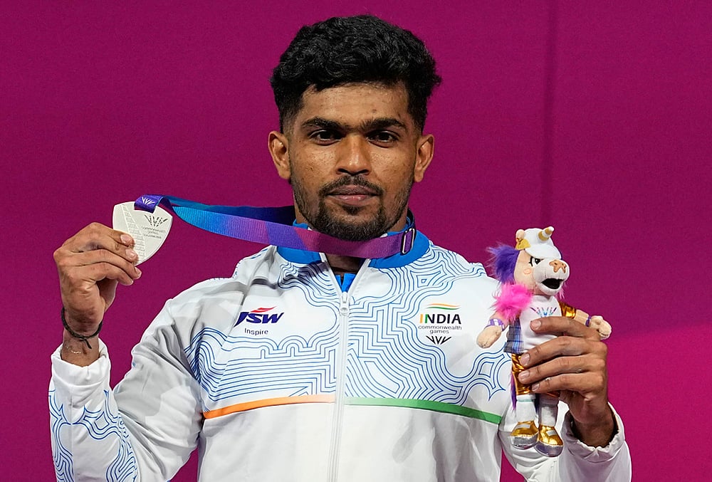 | Photo: AP/Manish Swarup : Indias Muthupandi Raja celebrates after wining silver medal in the men 65 kilogram weightlifting during the Commonwealth Games in Glasgow, Scotland, Sunday, July 26, 2026. 