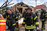 Andrii Marienko : Rescuers carry a body that they removed from under the rubble of a private house following a drone attack from Russia, in Kharkiv, Ukraine, Sunday, July 26, 2026.
