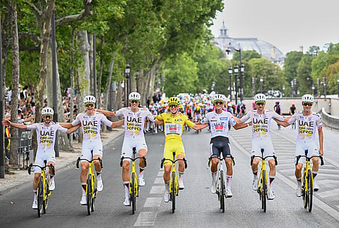 Slovenia's Tadej Pogacar, wearing the overall leader's yellow jersey, celebrates with his UAE Team Emirates XRG teammates during the last stage of the Tour de France cycling race in Paris, Sunday, July 26, 2026. 