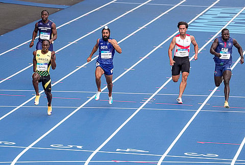India's Gurindervir Singh, right, Jamaica's Rohan Watson, left front, compete in the men's 100m round 1 heat 4 athletics at the 23rd Commonwealth Games, in Glasgow, Scotland.