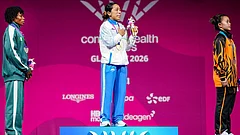 India's gold medallist Mirabai Chanu, centre, Nigeria's silver medallist Ruth Asuquo Nyong, left, and Malaysia's bronze medallist Irene Jane Henry during the presentation ceremony after the women's 48kg Final weightlifting competition at the 23rd Commonwealth Games, in Glasgow, Scotland. - | Photo: PTI/Ravi Choudhary