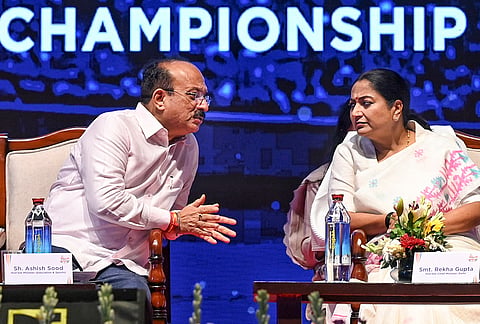Delhi Chief Minister Rekha Gupta interacts with state Minister Ashish Sood during the opening ceremony of the Commonwealth Table Tennis Championships 2026, at Thyagraj Stadium, in New Delhi.