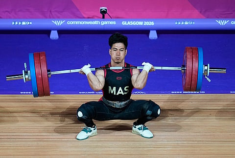 Malaysia's Muhamad Aznil competes in the men 65 kilogram weightlifting during the Commonwealth Games in Glasgow, Scotland, Sunday, July 26, 2026. 
