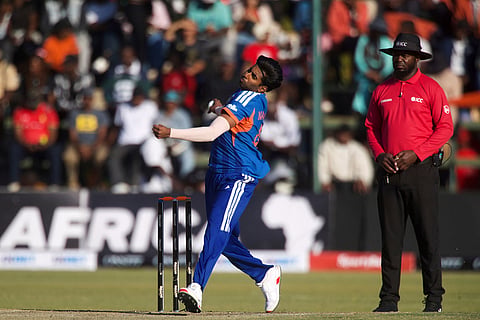 India's bowler Mayank Yadav, left, bowls as umpire Forster Mutizwa of Zimbabwe, watches on during the third T20 cricket match between Zimbabwe and India in Harare, Zimbabwe.