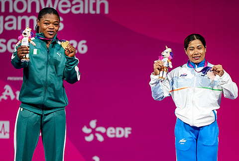 Gold medallist Lawal Rafiatu Folashade of Nigeria, left, and bronze medallist Bindyarani Devi of India pose with their medals and mascots during the medal ceremony for the Women's 58kg weightlifting event at the Commonwealth Games 2026, in Glasgow, Scotland, Monday, July 27, 2026. 
