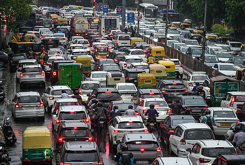 Vehicles remain stuck in traffic on a waterlogged road amid heavy rain, in the ITO area, New Delhi, Tuesday, July 28, 2026. 