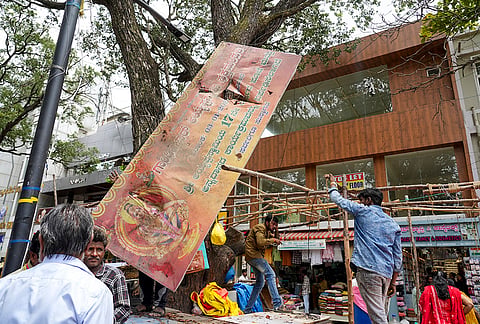 Greater Bengaluru Authority workers carry out an eviction drive on a footpath, in Bengaluru.