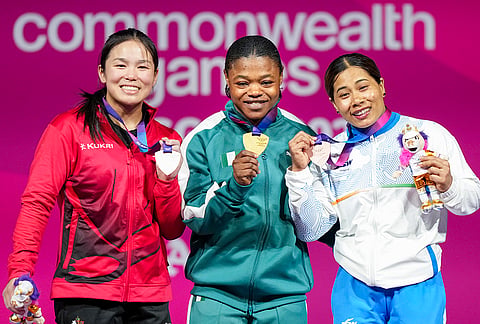Gold medallist Rafiatu Folashade Lawal of Nigeria, centre, silver medallist Ann Sophie Taschereau of Canada, left, and bronze medallist Bindyarani Devi of India pose during the medal ceremony for the Women's 58kg weightlifting event at the Commonwealth Games 2026, in Glasgow, Scotland, Monday, July 27, 2026. 