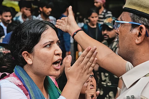 Frayed Tempers: A protester and a policeman captured while having a heated argument  