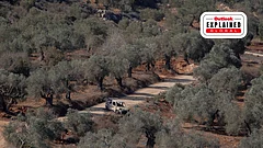 A burned-out vehicle sits on a dirt road among olive trees in the village of Baita, south of Nablus in the West Bank. Tensions have risen in the area as settlers and Israeli forces confront Palestinians - | IMAGO/ Middle East
