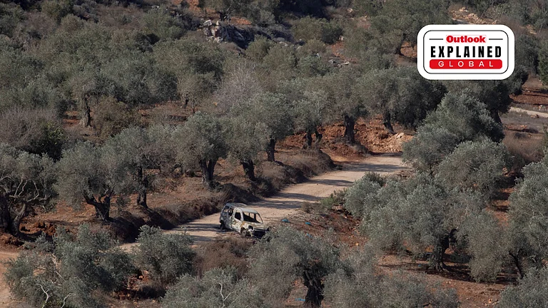 A burned-out vehicle sits on a dirt road among olive trees in the village of Baita, south of Nablus in the West Bank. Tensions have risen in the area as settlers and Israeli forces confront Palestinians - | IMAGO/ Middle East