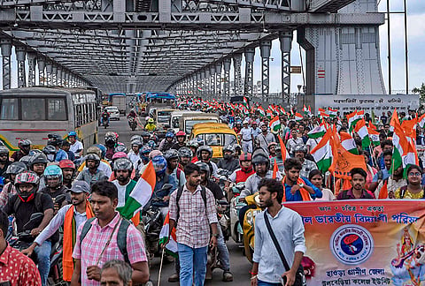 Students, teaching staff and others take part in 'Desh Bachao' (save the nation) rally from Howrah and Sealdah station to Dharmatala, organised by BJP supporters to protest against the violence during NEET protest, in Kolkata, West Bengal.