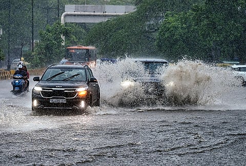 Vehicles move through a waterlogged road amid heavy rain, in the Nizamuddin area, New Delhi, Tuesday, July 28, 2026.