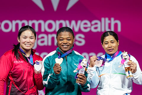 Gold medallist Rafiatu Folashade Lawal of Nigeria, centre, silver medallist Ann Sophie Taschereau of Canada, left, and bronze medallist Bindyarani Devi of India pose during the medal ceremony for the Women's 58kg weightlifting event at the Commonwealth Games 2026, in Glasgow, Scotland, Monday, July 27, 2026. 