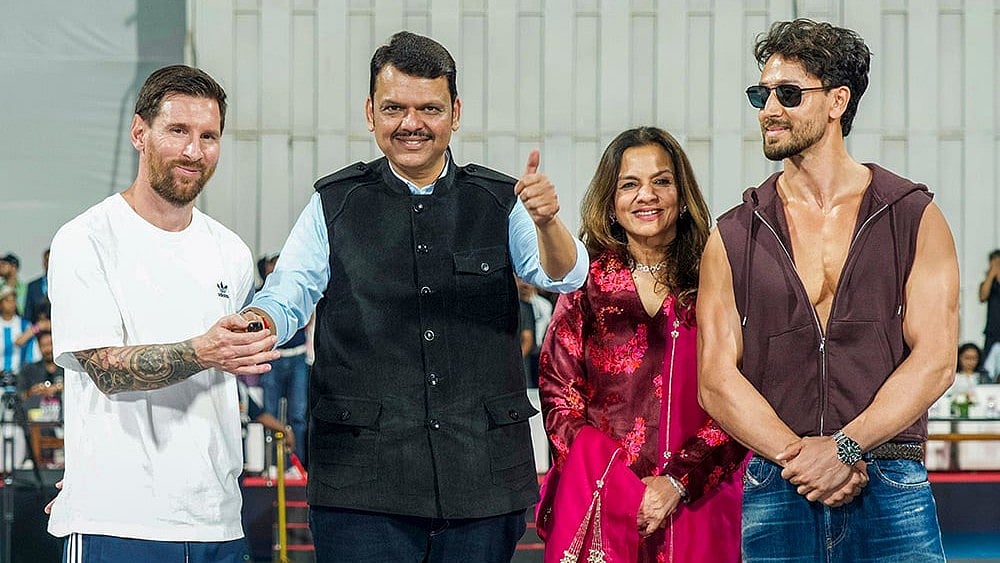 Argentine football superstar Lionel Messi, left, Maharashtra Chief Minister Devendra Fadnavis, second left, Bollywood actor Tiger Shroff, right, and others during an event as part of the 'GOAT India Tour 2025', at the Wankhede Stadium, in Mumbai.  - | Photo: @CMOMaharashtra/X via PTI 