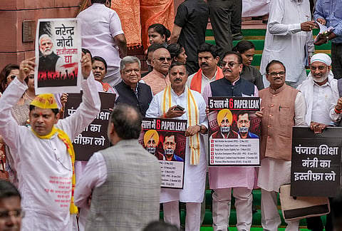 BJP MP Darshan Singh Choudhary and others stage a protest during the Monsoon session of Parliament, in New Delhi.