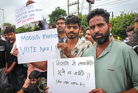 Farmers under the banner of Samyukt Kisan Morcha hold placards as they stage a protest to press for various demands, including 100 per cent moong procurement at MSP, in Bhopal, Madhya Pradesh, Wednesday, July 29, 2026. 