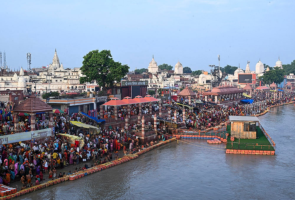| Photo: PTI : People take a holy dip in the Saryu river on the occasion of Guru Purnima festival, at Shiva Temple, in Ayodhya, Uttar Pradesh.