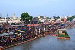 People take a holy dip in the Saryu river on the occasion of 'Guru Purnima' festival, at Shiva Temple, in Ayodhya, Uttar Pradesh. - | Photo: PTI
