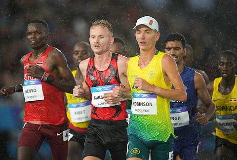Ky Robinson, of Australia, and David Mullarkey, of Isle of Man, compete in the men's 10,000 meters final at the Commonwealth Games in Glasgow, Scotland, Tuesday, July 28, 2026.