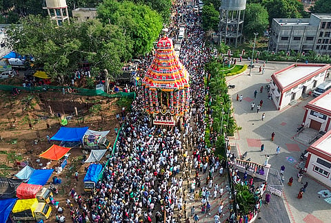 People take part in the 'Aadi Thiruvizha' festival procession at the Arulmigu Kallalagar Temple, Alagarkovil, in Madurai district, Tamil Nadu.