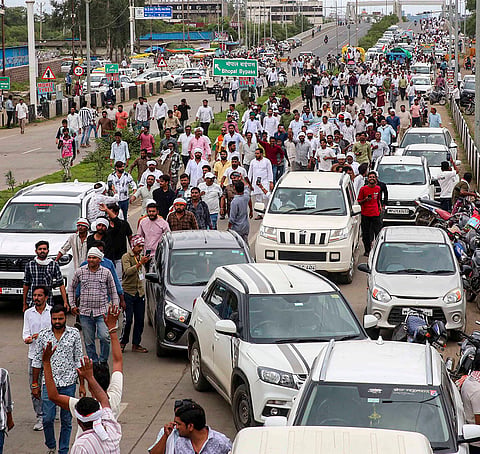 Farmers under the banner of the Samyukt Kisan Morcha (SKM) during their Kisan Kranti Padyatra march from Narmadapuram to Bhopal, demanding 100 per cent procurement of moong at the Minimum Support Price (MSP) and other issues, on the outskirts of Bhopal, Tuesday, July 28, 2026. 