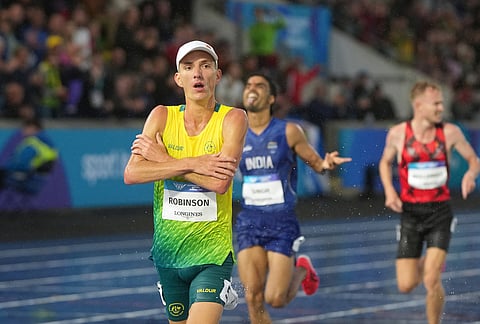 Ky Robinson, of Australia, crosses the finish line ahead of Gulveer Singh, of India, and David Mullarkey, of Isle of Man, to win the gold medal in the men's 10,000 meters final at the Commonwealth Games in Glasgow, Scotland, Tuesday, July 28, 2026. 