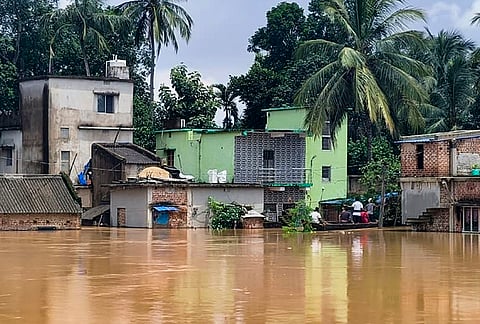 People use a countryboat in floodwater, in Jajpur district, Odisha, Wednesday, July 29, 2026. In view of the situation, schools and anganwadi centres in 10 districts have been ordered to remain closed. 